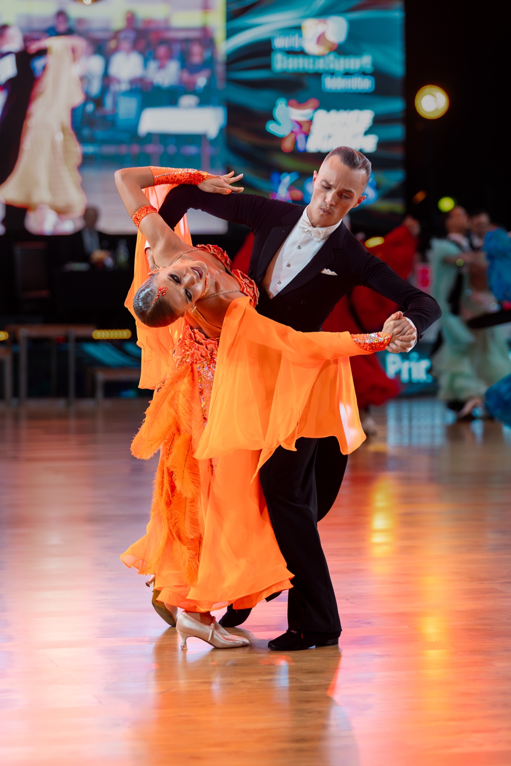 Ballroom dance couple performing on the competition floor